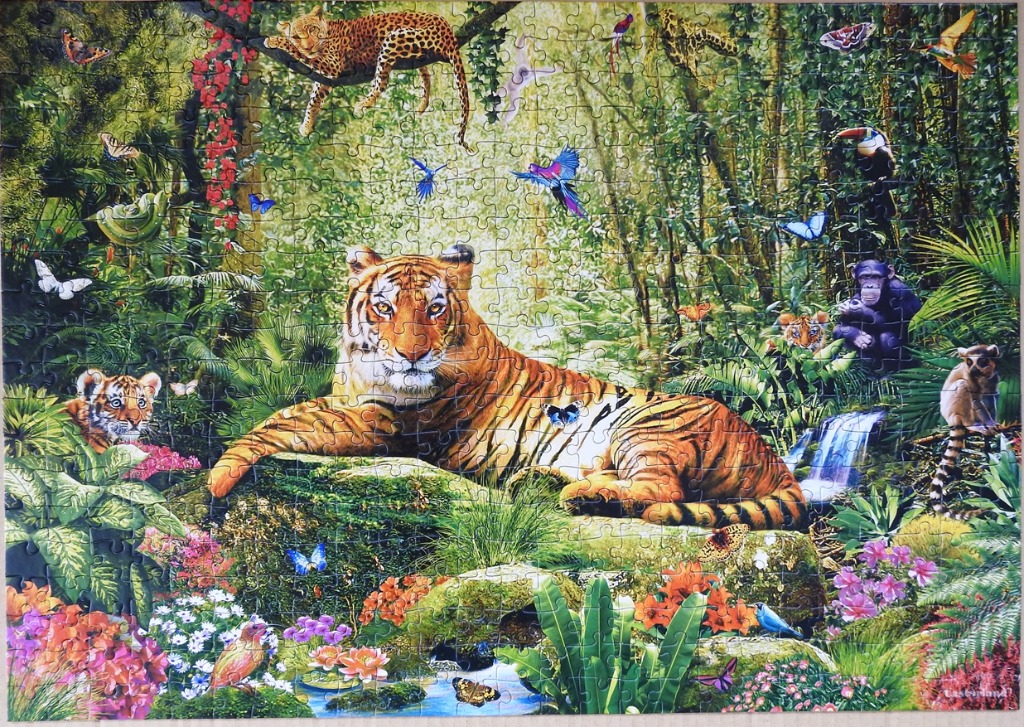 A lush rainforest scene featuring a large tiger resting on a rock surrounded by diverse jungle animals and flora.