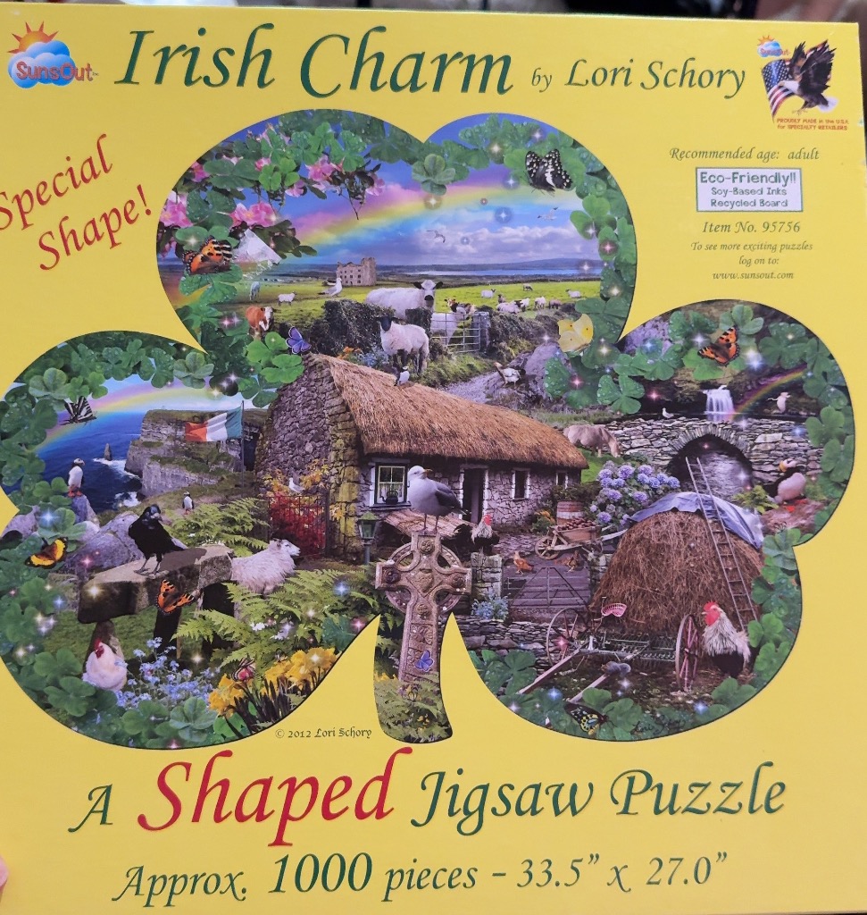 A whimsical clover-shaped collage of Irish countryside imagery featuring a stone cottage, livestock, and a rainbow.
