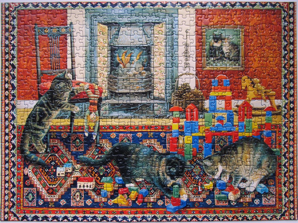 Three cats playing in a cozy, antique-style nursery with a fireplace and toy blocks.