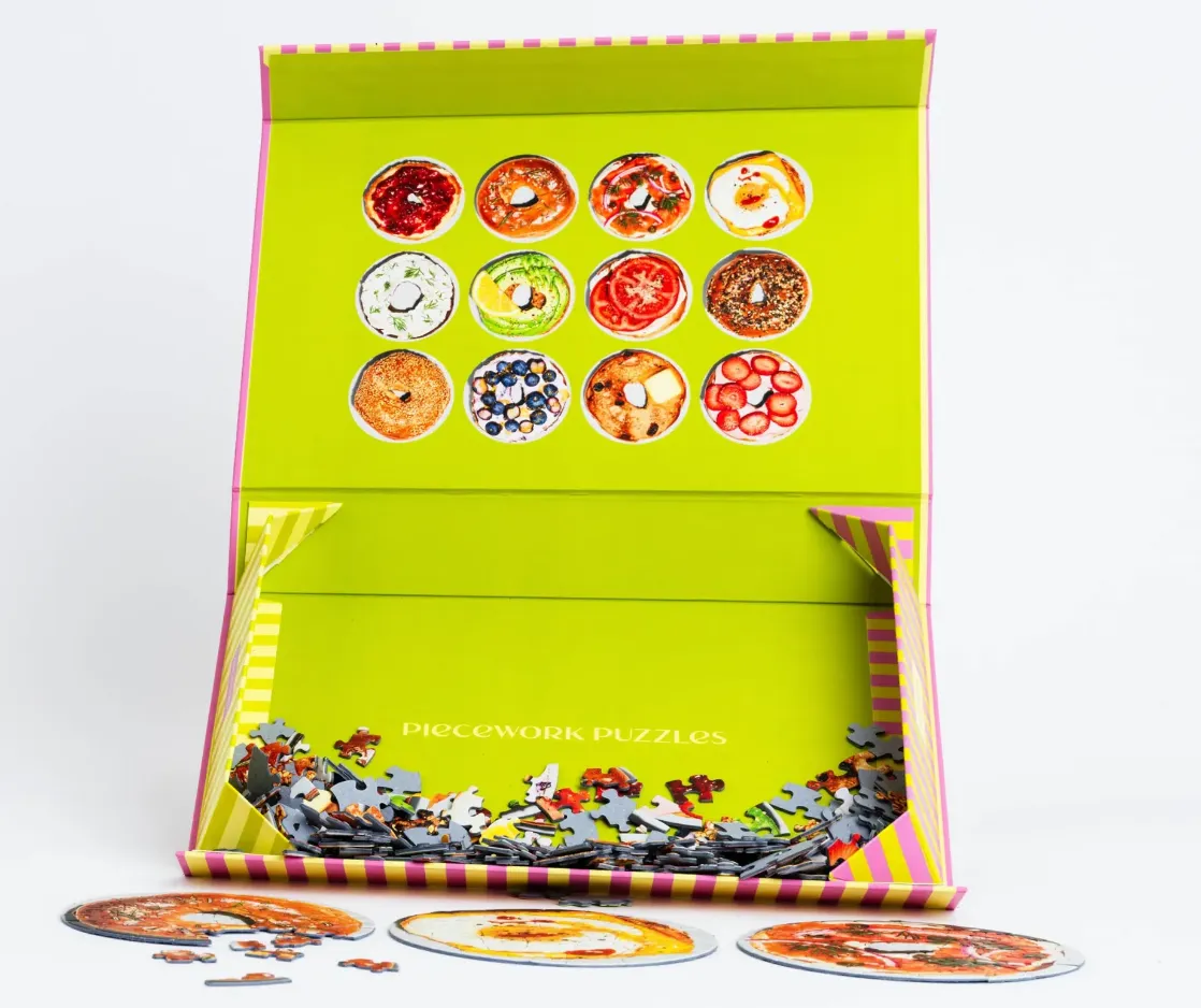 A collection of twelve round images of decorated bagels arranged in a grid against a bright lime green background.