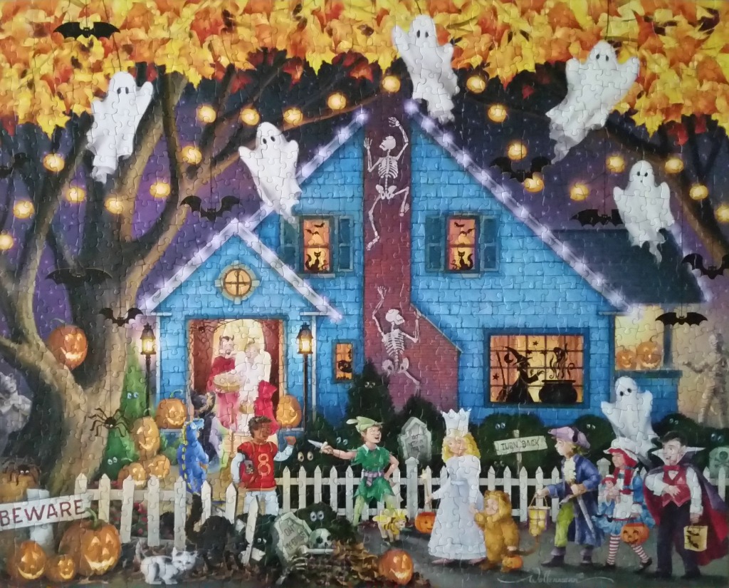 A Halloween scene featuring a blue house decorated for trick-or-treating with ghosts, skeletons, and costumed children.