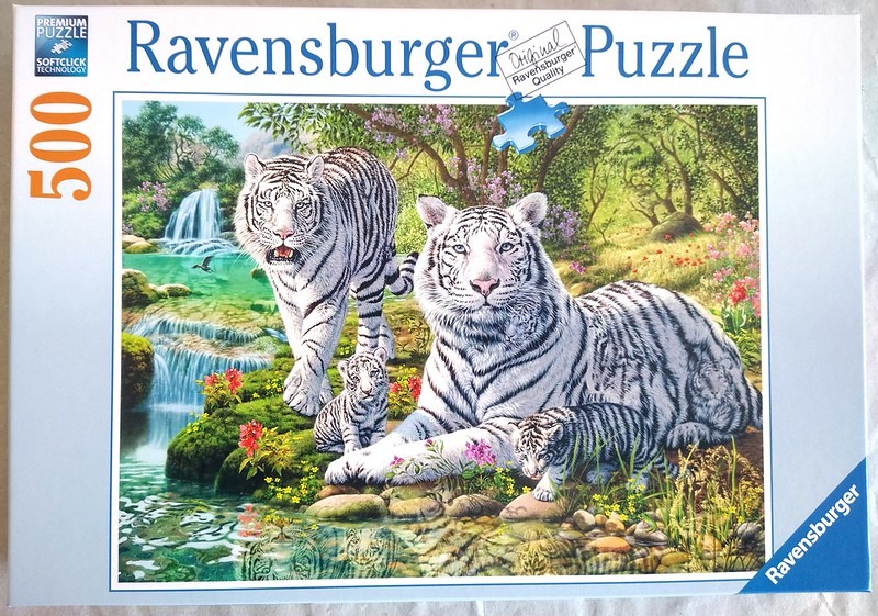 A family of four white tigers near a jungle waterfall