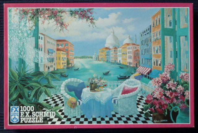 An oil painting of a Venetian canal view from a balcony with white wicker chairs and a table set for two.