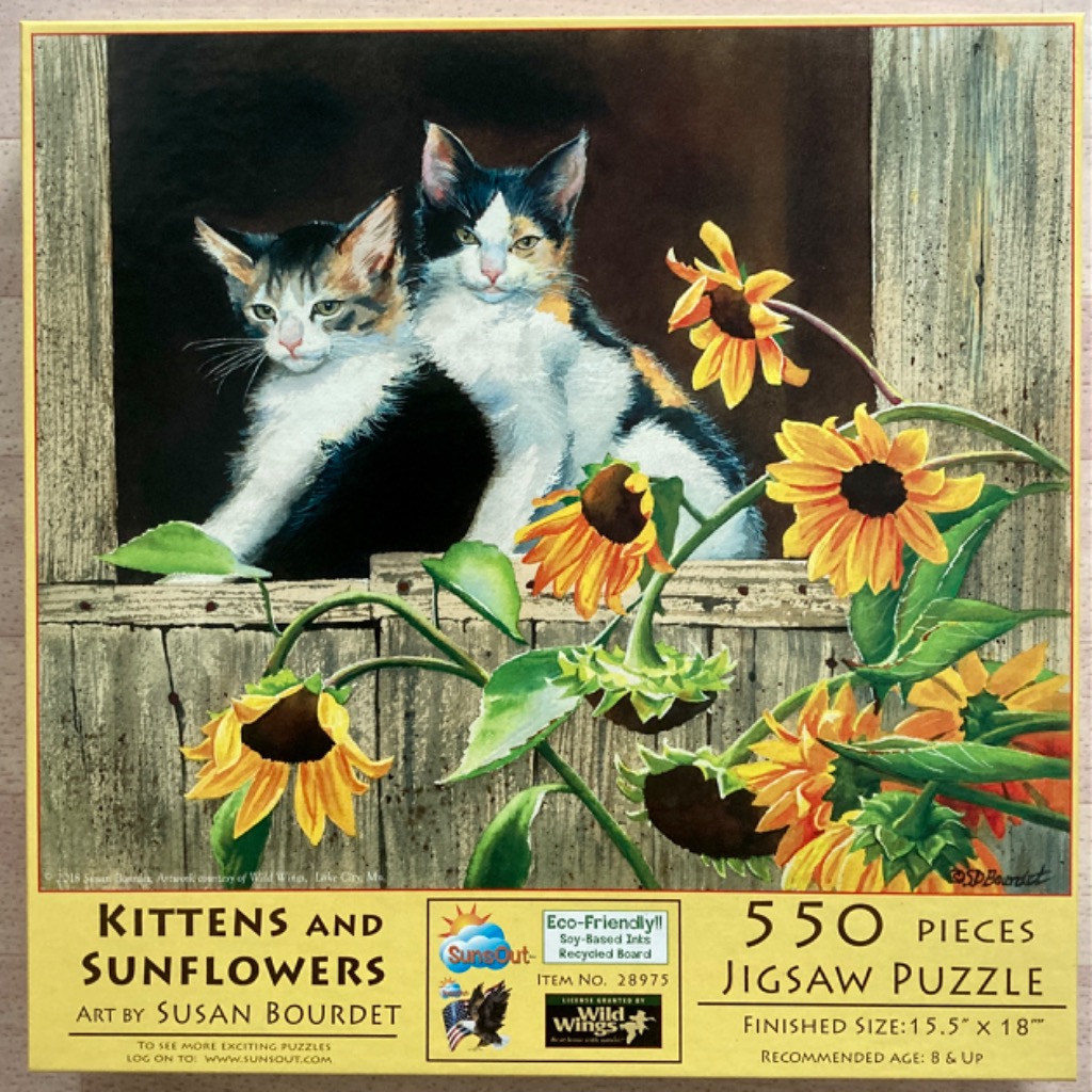 Two calico kittens peeking out of a rustic wooden barn window framed by sunflowers.