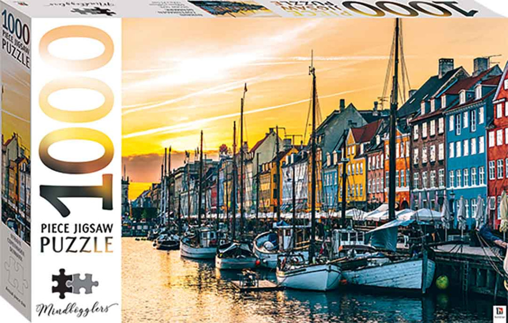Nyhavn harbor in Copenhagen at sunset with colorful buildings and sailboats