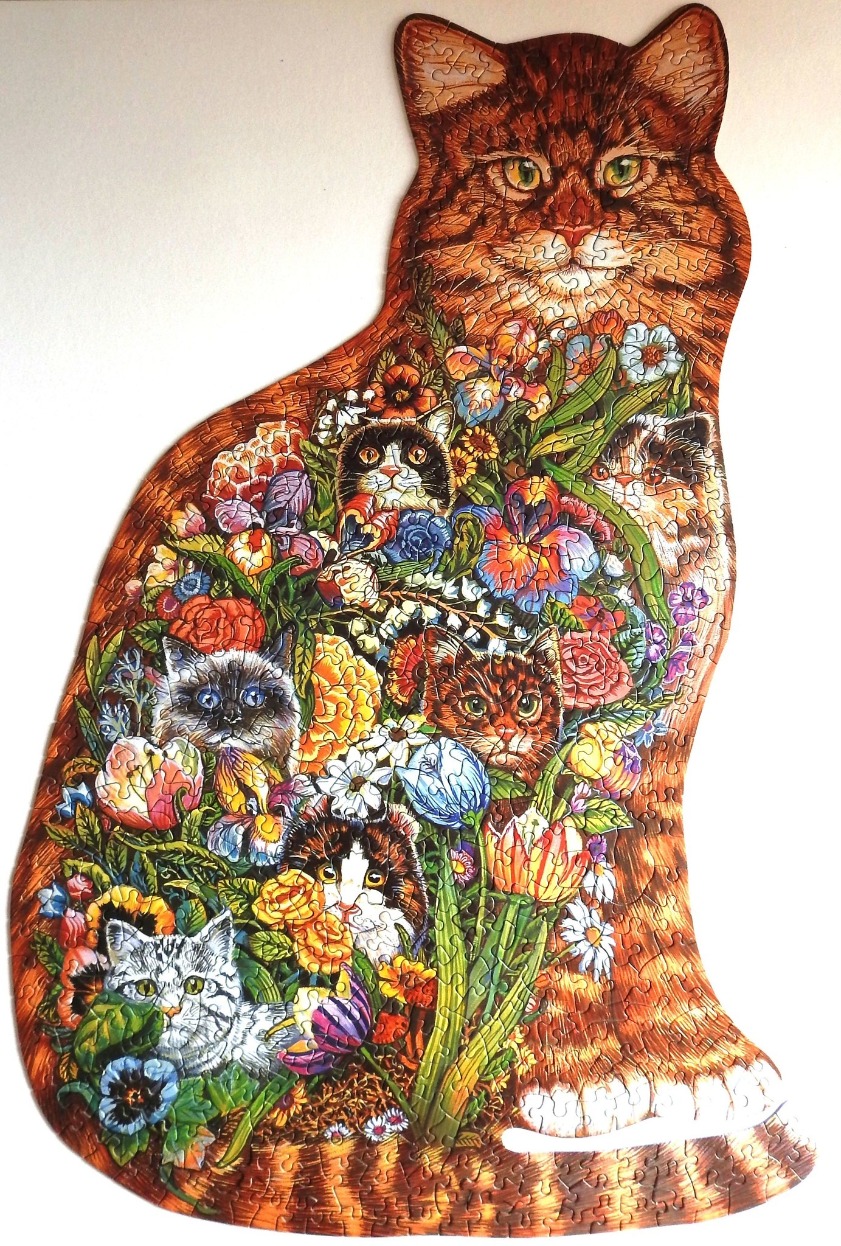 An illustration of a large tabby cat shaped like a cat, filled with flowers and small kitten faces.