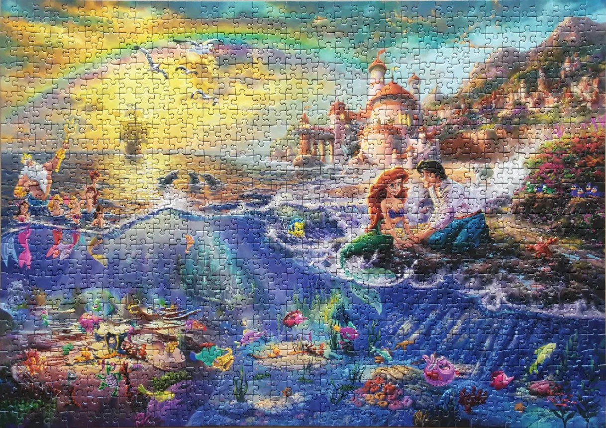 An animated illustration showing a split view of an underwater kingdom and a sunlit coastal scene with merfolk.