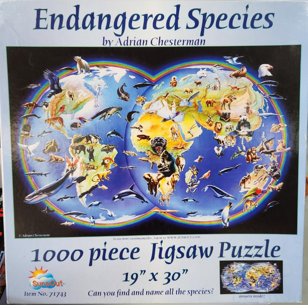 A double-globe world map illustration populated with various endangered animals, framed by a colorful rainbow.