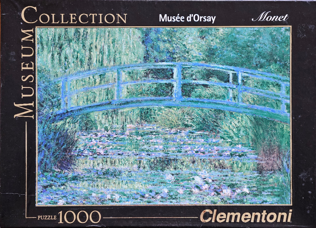 Impressionist painting of a blue arched Japanese-style footbridge over a lily pond with lush green foliage.