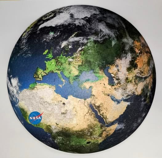 Circular satellite-style view of Earth focusing on Europe, Africa, and the Middle East.