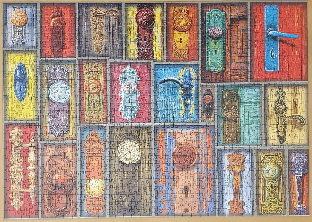 A collage of diverse vintage door hardware, including various ornate metal handles, plates, and knobs.