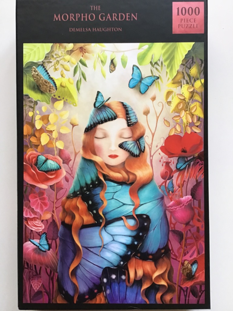 Artistic illustration of a woman with long ginger hair draped in vibrant blue butterfly wings in a dreamlike garden.