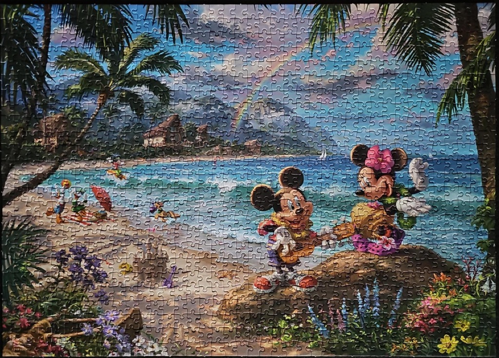 Mickey and Minnie Mouse playing music on a sunny tropical beach scene with palm trees and a rainbow.