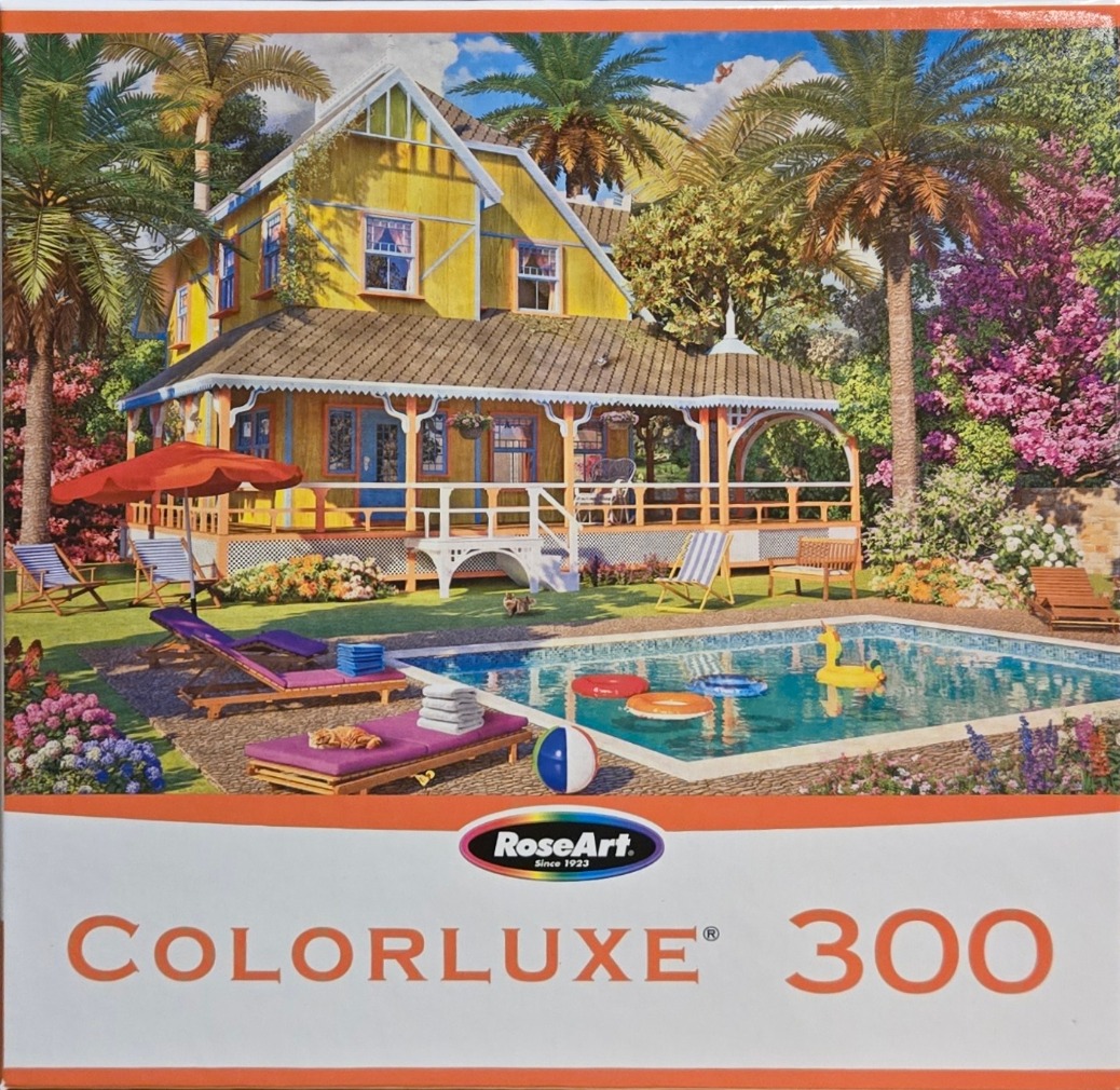A sunny, tropical backyard with a yellow cottage, swimming pool, and lounge chairs.