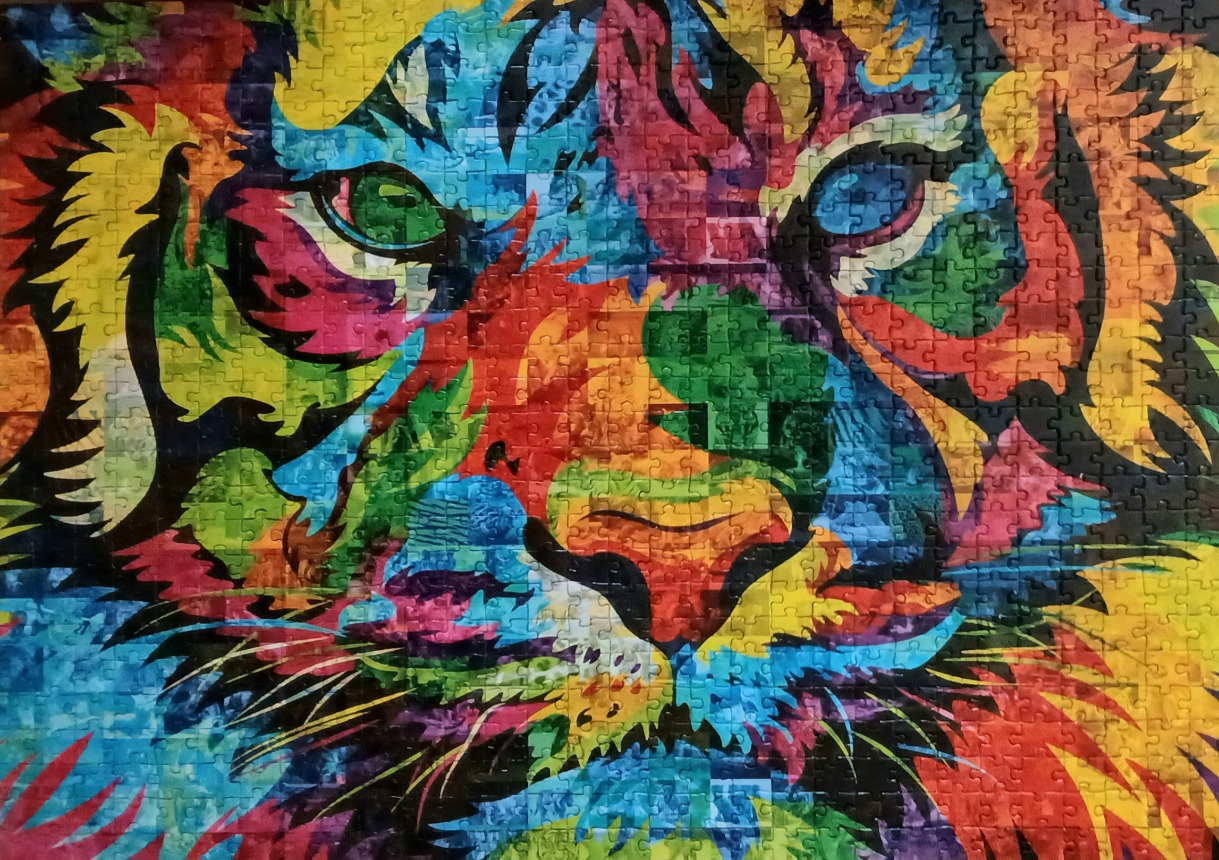 A close-up, colorful pop art portrait of a tiger's face.