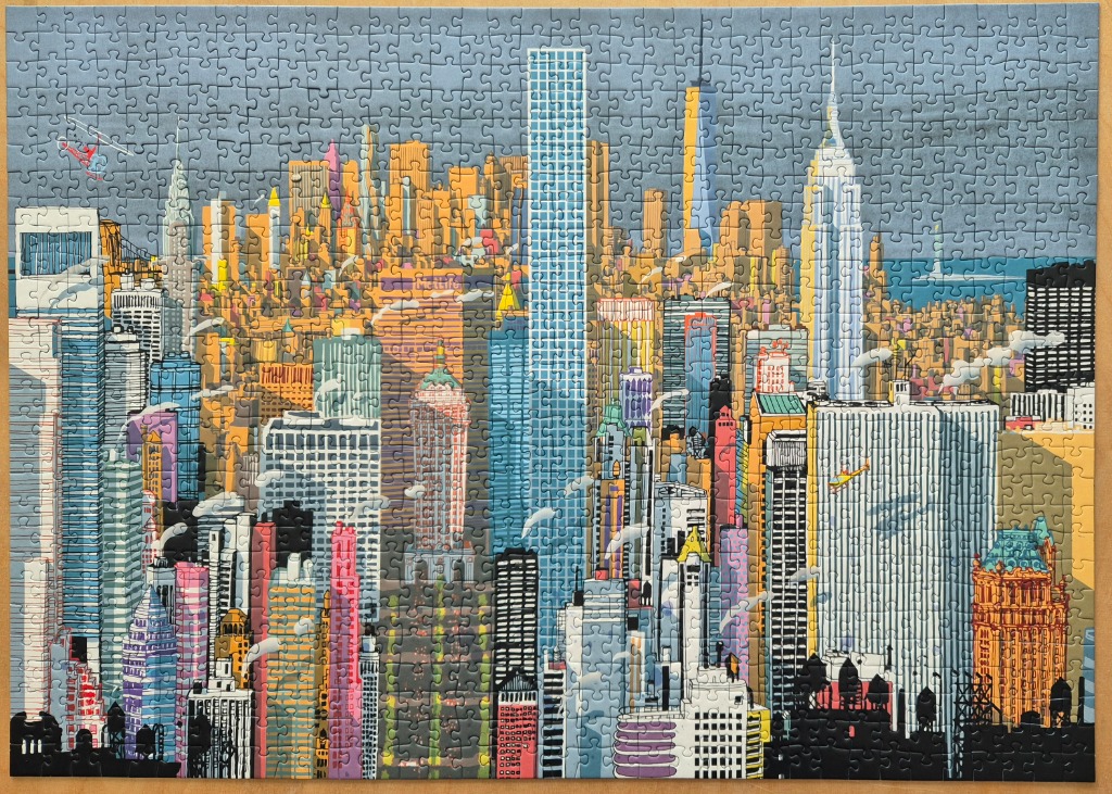 An illustrated, stylized depiction of the New York City skyline featuring vibrant skyscrapers under a grey sky.