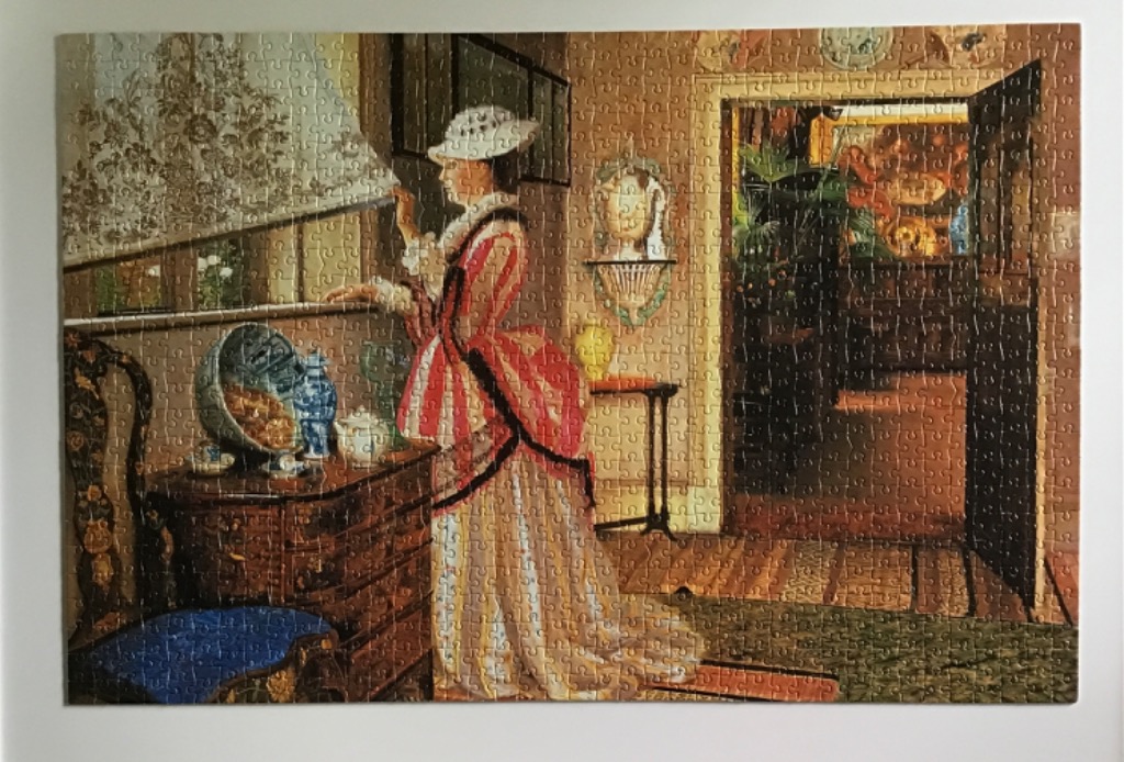 A woman in an 18th-century style dress stands at a window in a warm-toned, traditional interior.