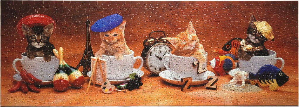 Four kittens in teacups representing different cultures and hobbies against a brown background.