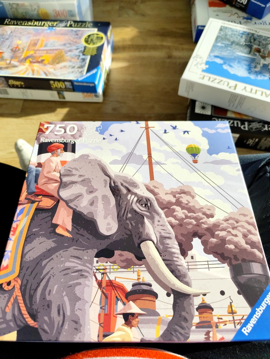 A stylized illustration of an elephant carrying a passenger on a dock with a steamboat and a hot air balloon.