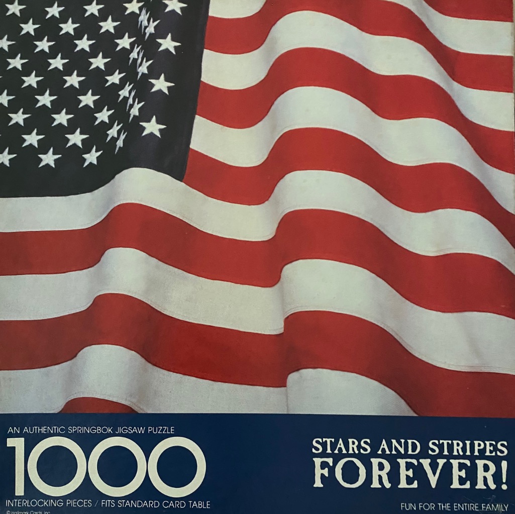 Close-up photograph of a wavy, textured American flag filling the frame.