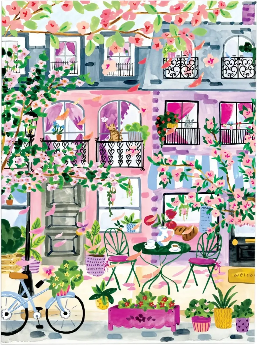 A charming street-level cafe scene in front of pink and lavender buildings, framed by cherry blossoms and potted plants.