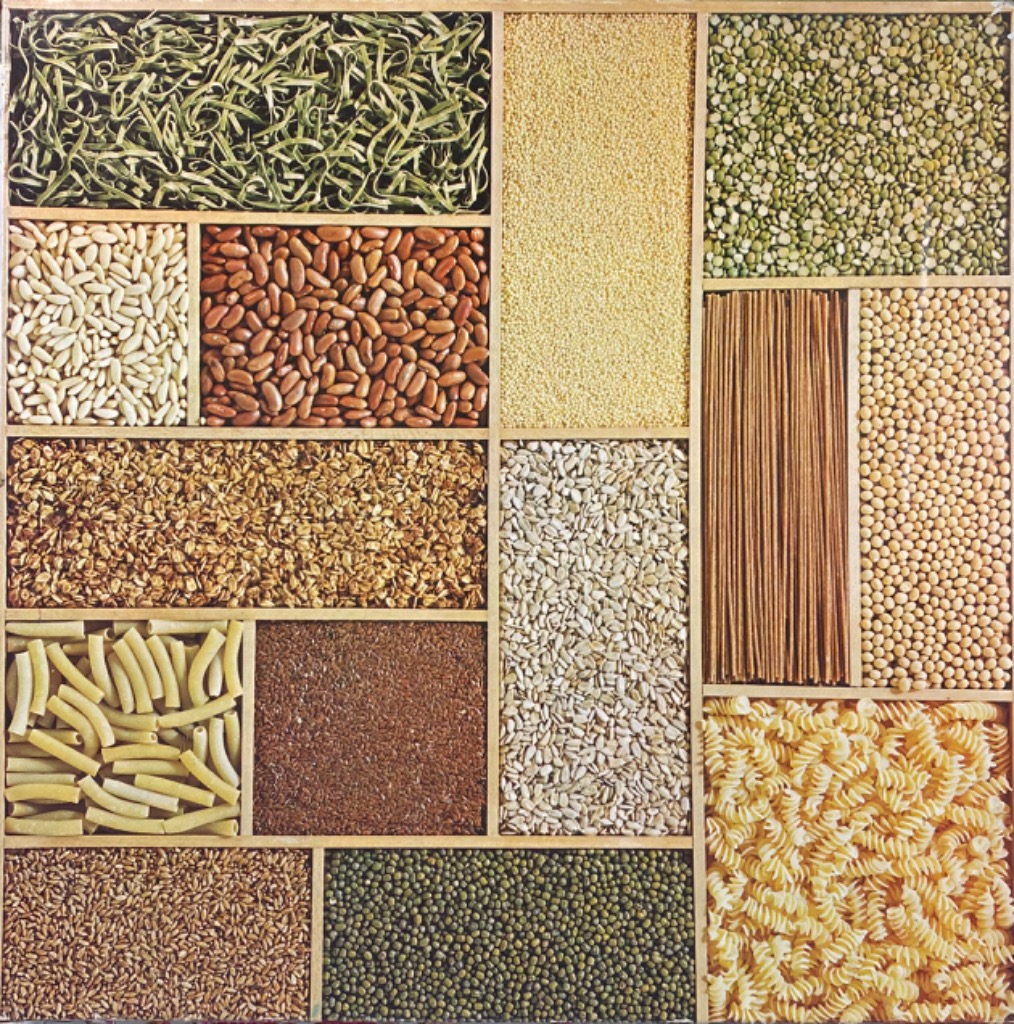 A grid of fourteen compartments filled with various dried pantry staples like beans, grains, and pastas.