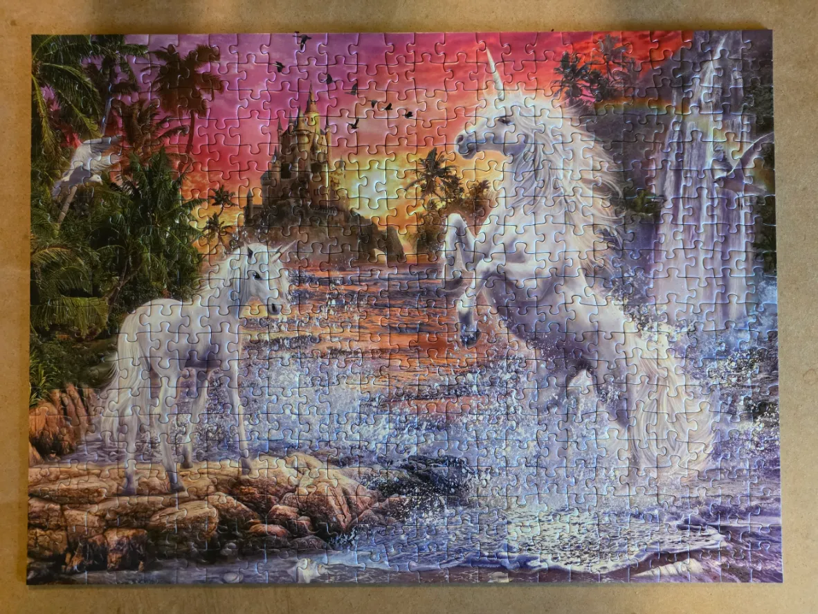 Two white unicorns in a tropical fantasy landscape with a distant castle at sunset.