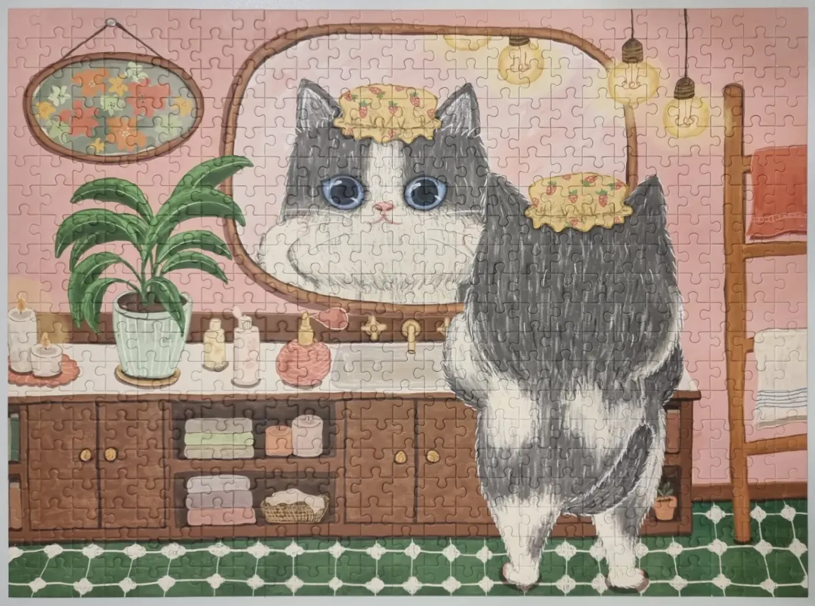 An illustration of a grey cat wearing a shower cap standing before a bathroom mirror.