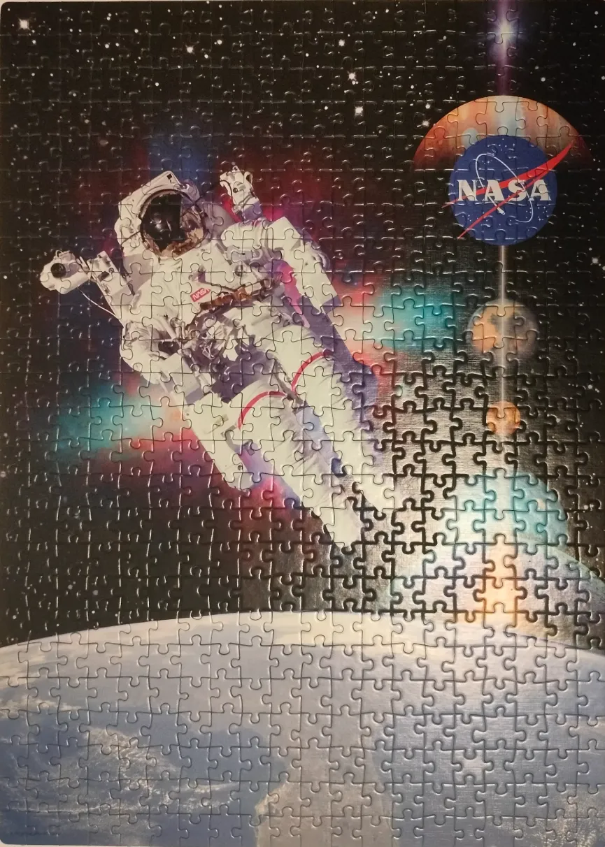 An astronaut floats in deep space above the Earth with a colorful nebula and a NASA logo visible.