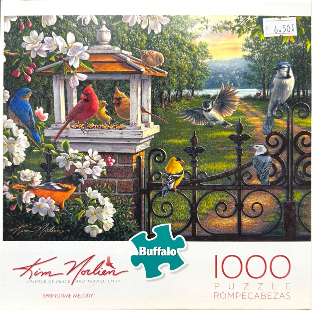 A peaceful garden scene filled with various colorful birds, a bird feeder, and white spring blossoms.