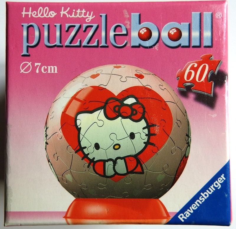 A spherical item featuring Hello Kitty against a large red heart design.