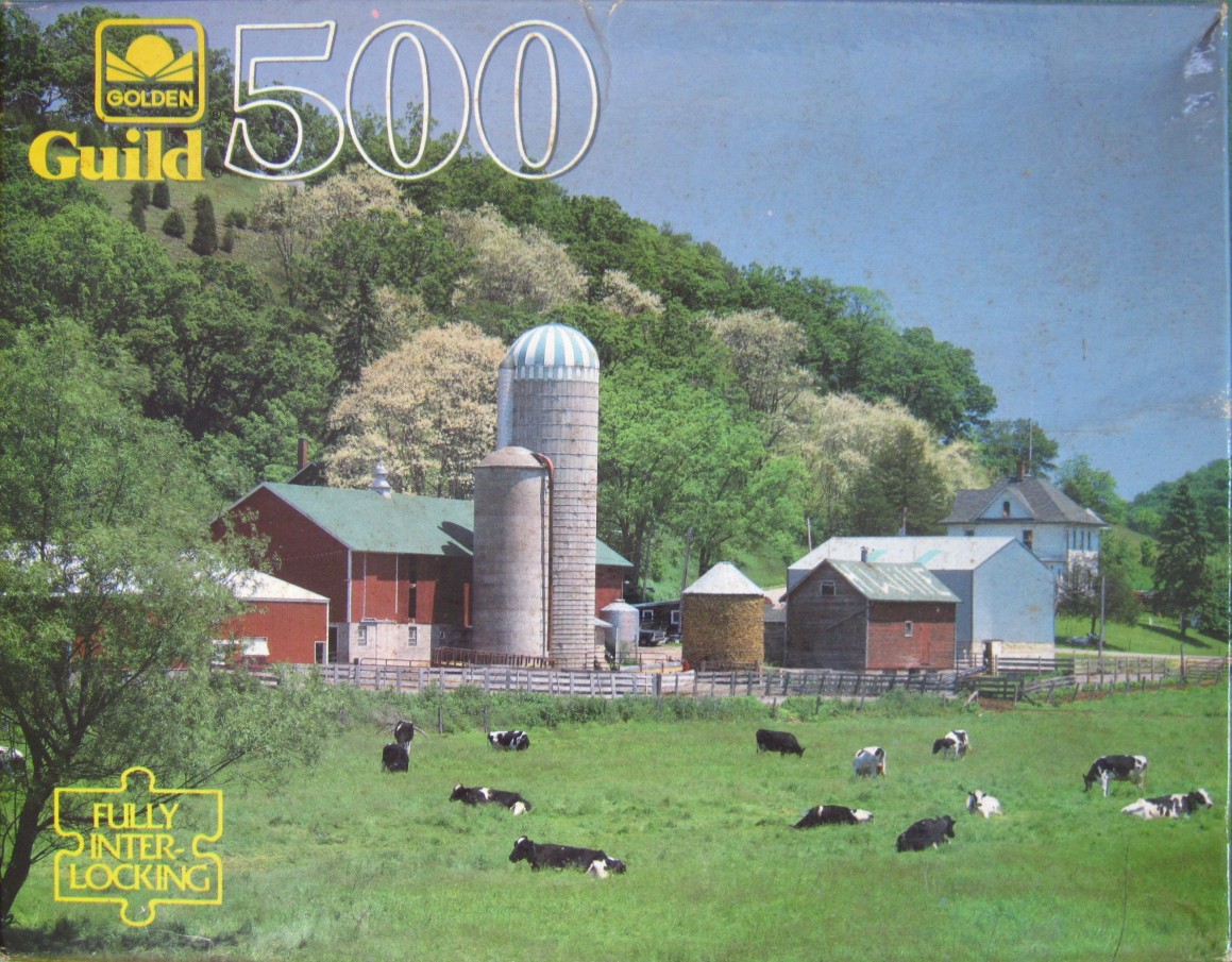 A countryside scene featuring a red barn, silos, and cows grazing in a green pasture.