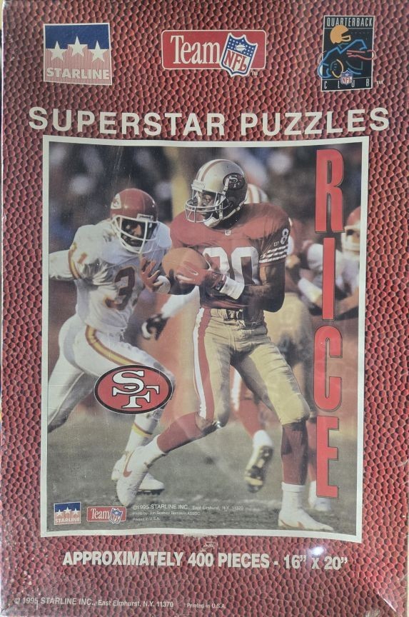 Jerry Rice running with a football in a San Francisco 49ers uniform during a game