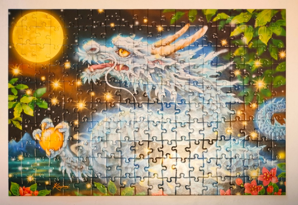A fantasy illustration of a white oriental-style dragon against a starry night sky with a full moon and golden orbs.