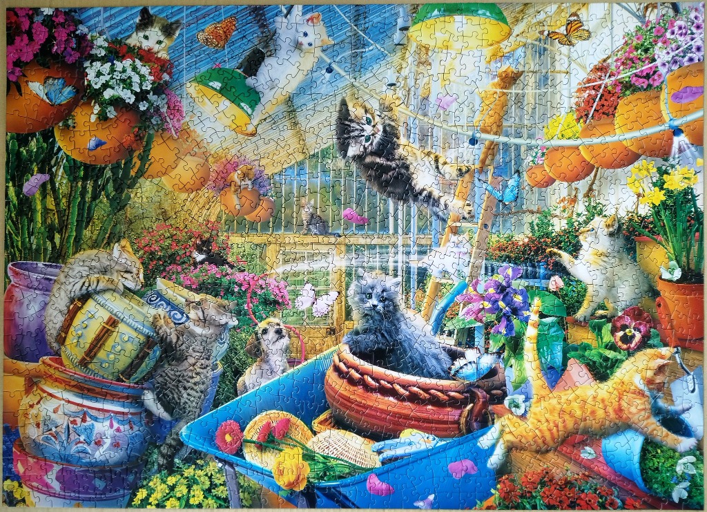 A vibrant greenhouse scene filled with playful kittens, colorful flowers, and butterflies.