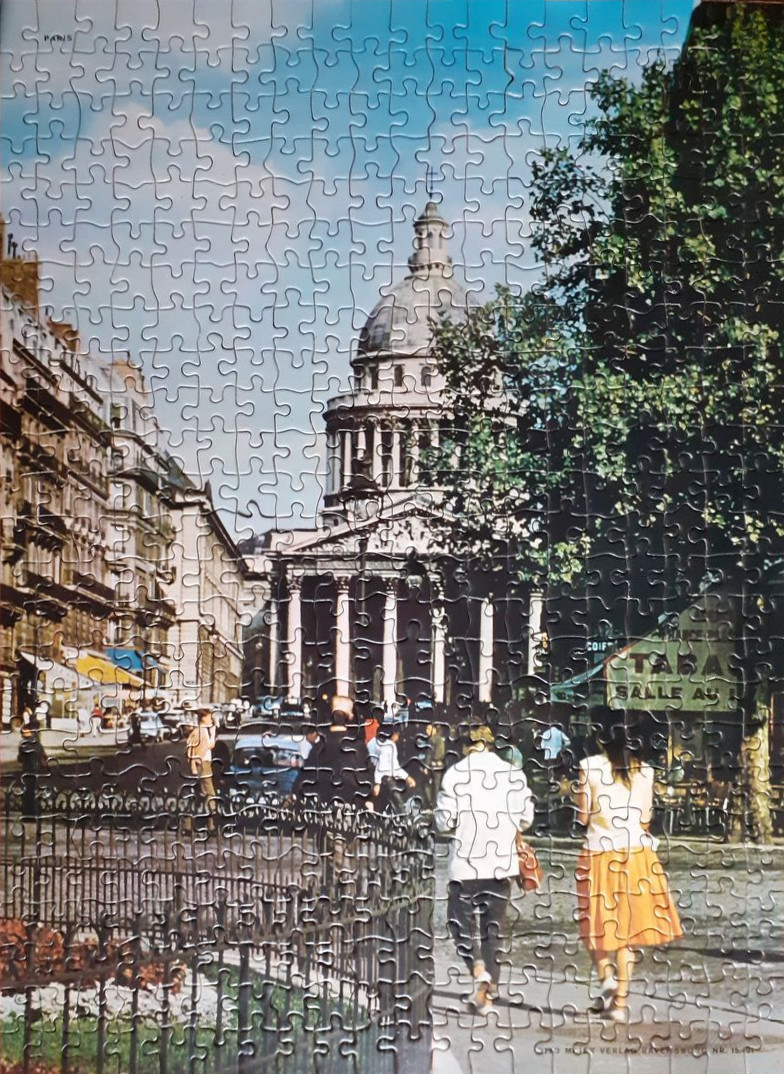 A vintage street scene in Paris featuring the Pantheon with pedestrians walking in the foreground.