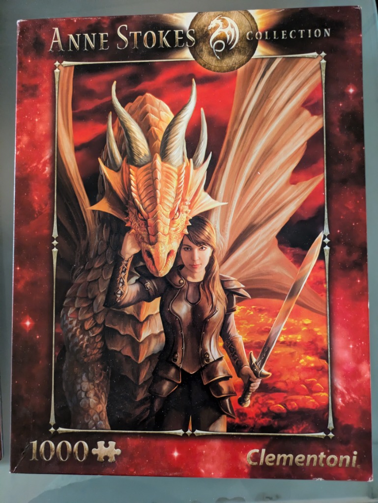 Fantasy illustration of a female warrior standing beside a large golden dragon against a fiery red background.