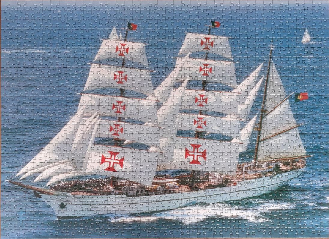 The Portuguese tall ship Sagres sailing on blue ocean water.