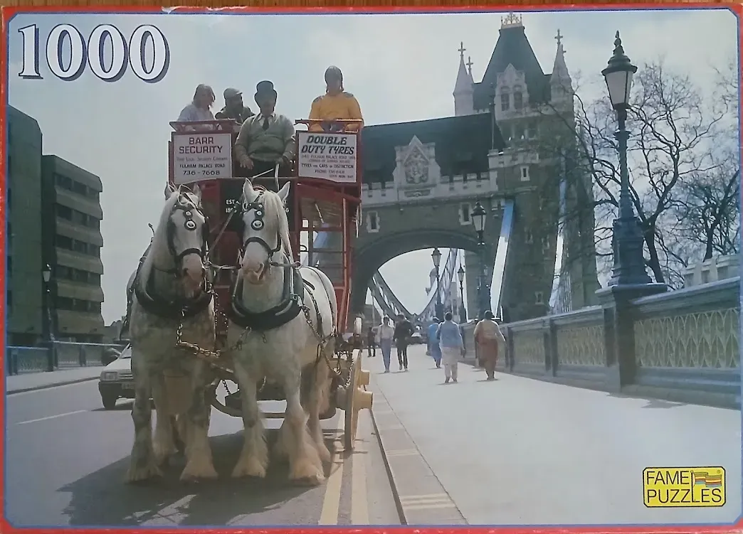 A horse-drawn carriage with passengers travels across Tower Bridge in London.