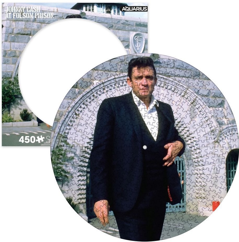 Johnny Cash standing in front of a stone prison archway on a circular background.