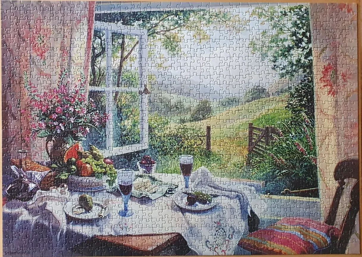 An open window looking out over a peaceful garden landscape with a table set for a meal in the foreground.