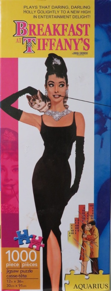 An illustration of Audrey Hepburn in a black dress with a tabby kitten and a couple kissing in the rain below.