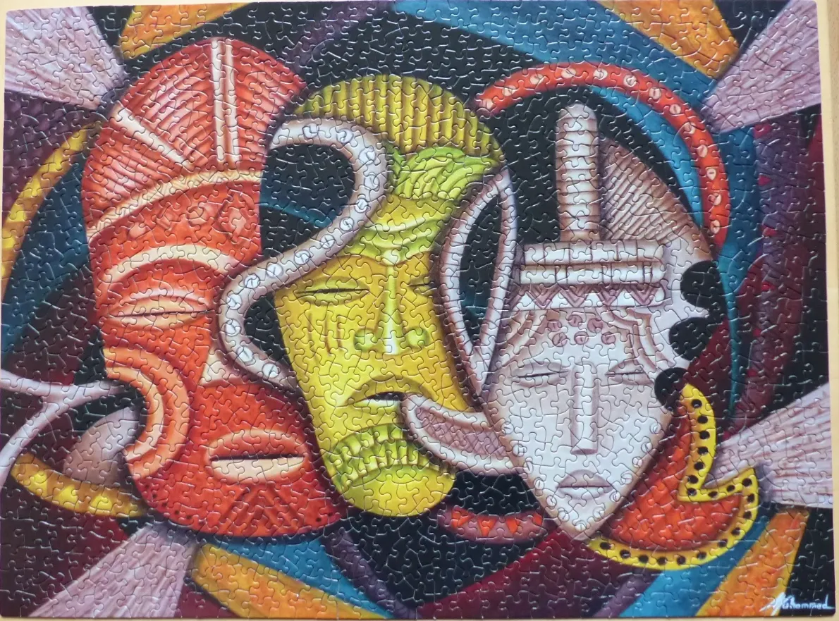 Stylized artwork featuring three interconnected tribal masks in red, yellow, and white
