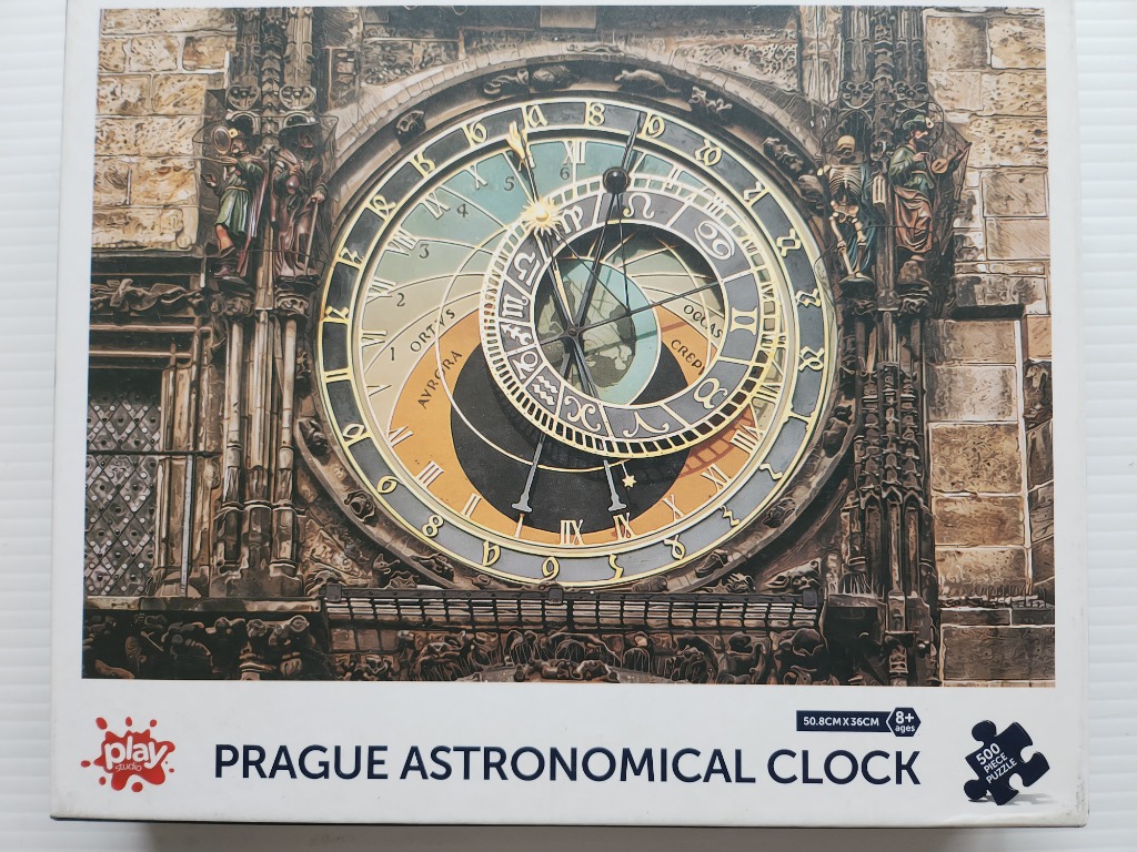 Close-up of the historical Prague Astronomical Clock face with ornate stonework and zodiac details.