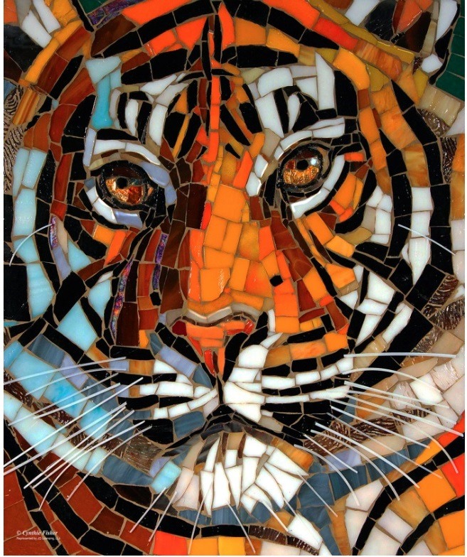 A close-up mosaic art piece depicting a tiger's face with vibrant orange, black, and white glass tiles.
