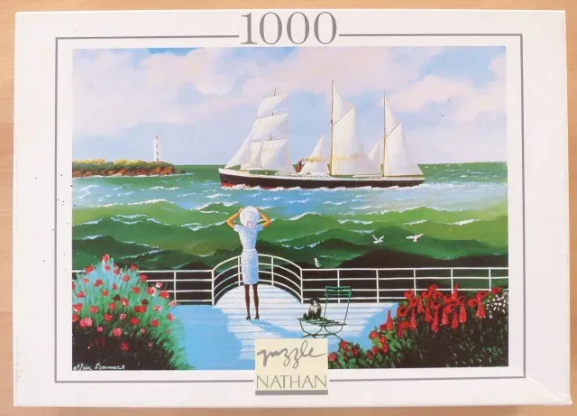 A woman in a white dress standing on a terrace overlooking a sailing ship on a choppy green sea.