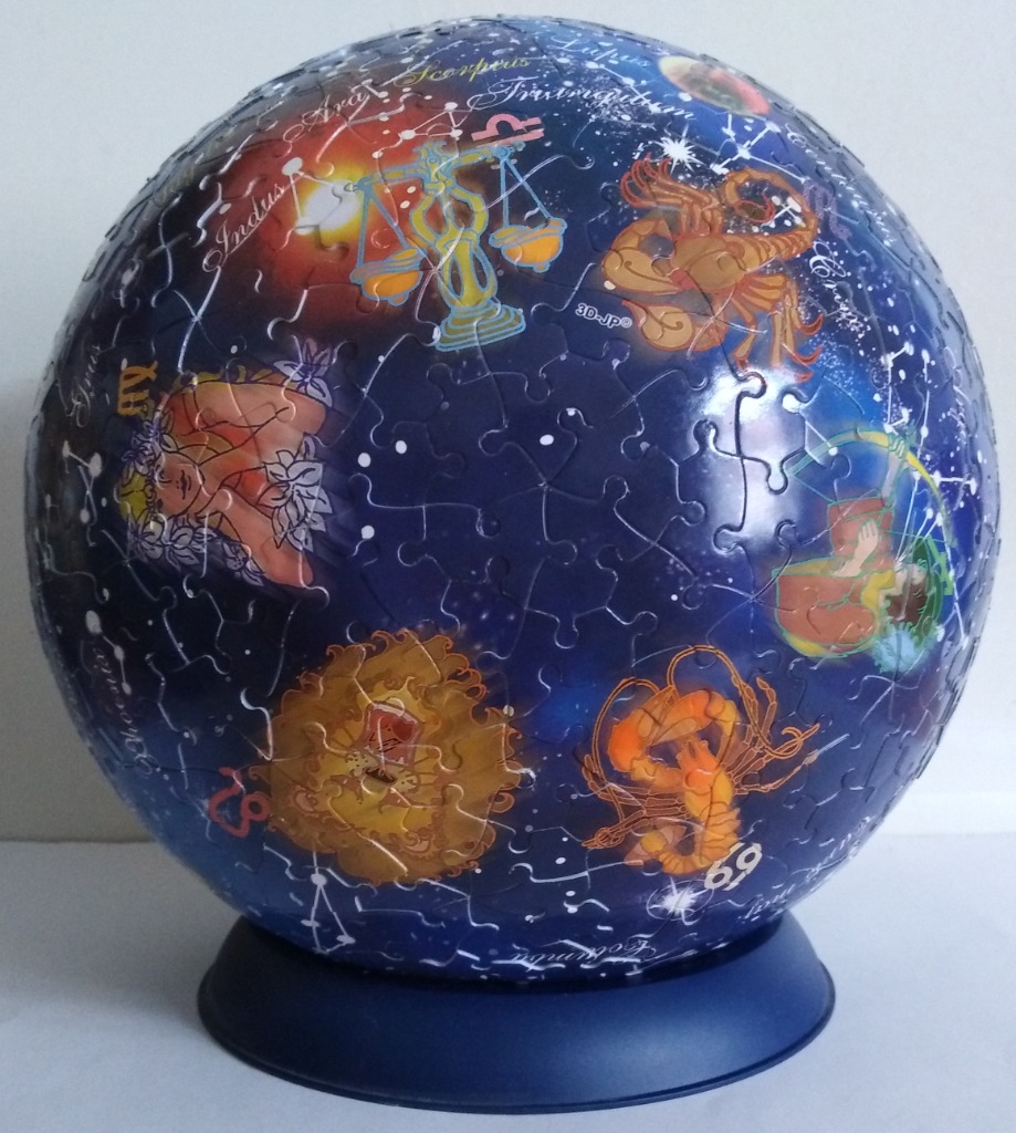 A spherical representation of the night sky featuring various golden zodiac constellations and symbols.