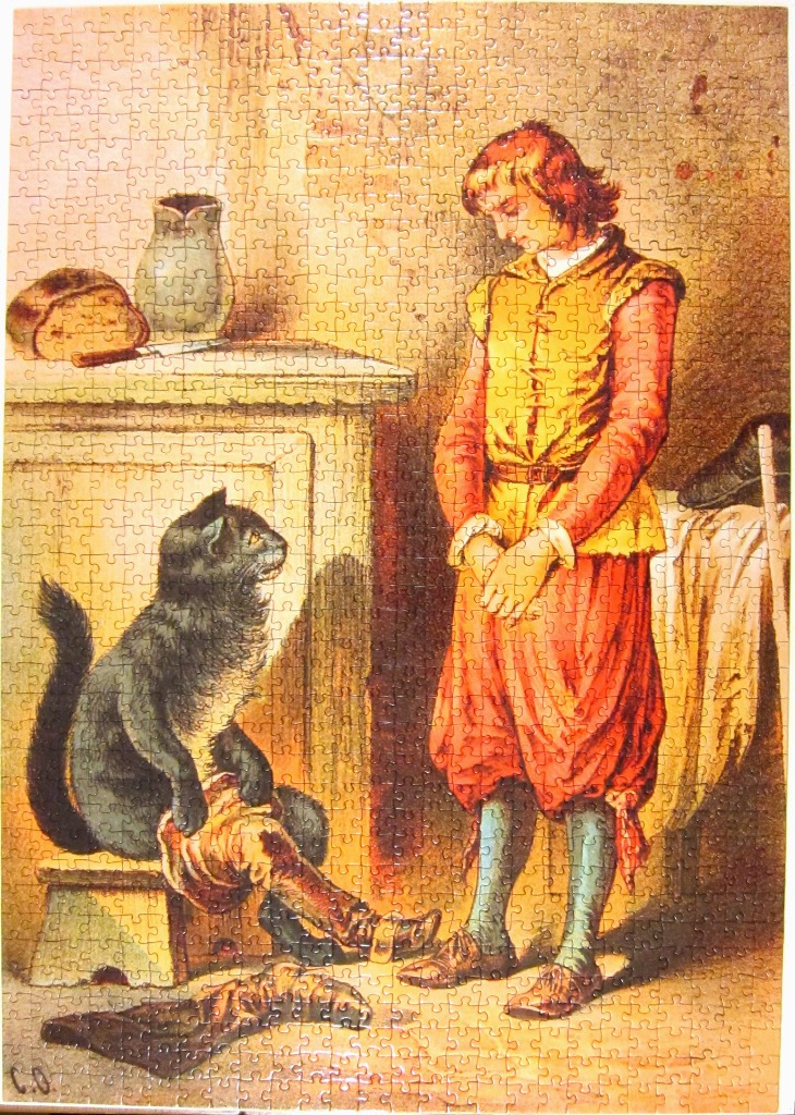 A young boy in medieval clothing looks down at a black cat wearing a leather boot in a rustic kitchen.