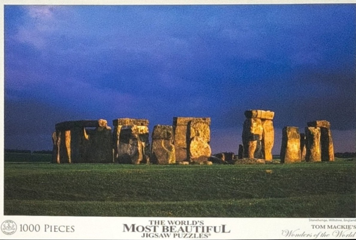 Stonehenge ruins in Wiltshire, England, under a deep blue sunset sky.