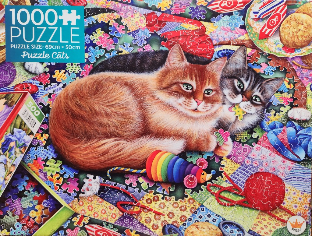 Two fluffy cats interacting with colorful yarn and puzzle pieces on a quilt background.